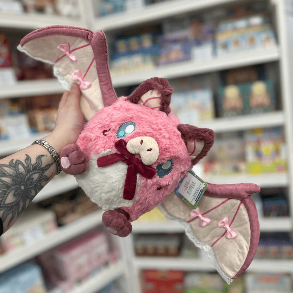Mini Squishable Sweetheart Bat plush toy held in hand with wings open, front view