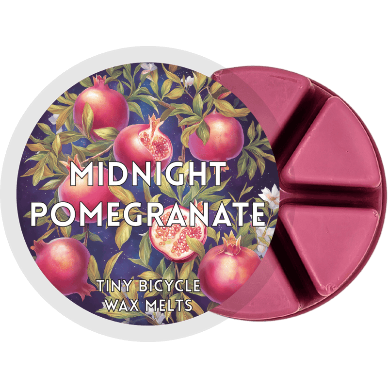 Midnight Pomegranate wax melt pot with six berry-red segments and pomegranate label artwork