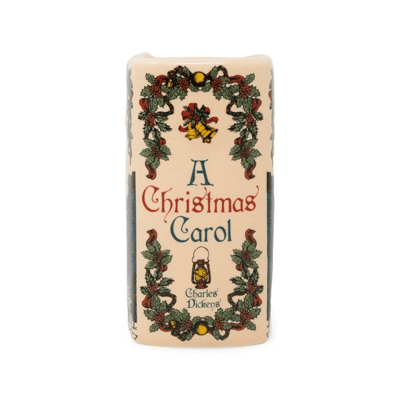 Decorative spine of A Christmas Carol book-shaped candle with holly, golden bells, lantern and Charles Dickens lettering