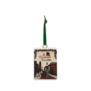 A Christmas Carol ceramic book Christmas tree decoration featuring an illustrated Victorian street scene and green hanging ribbon