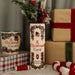 Ceramic A Christmas Carol book vase styled with festive stems beside matching mug and wrapped gifts