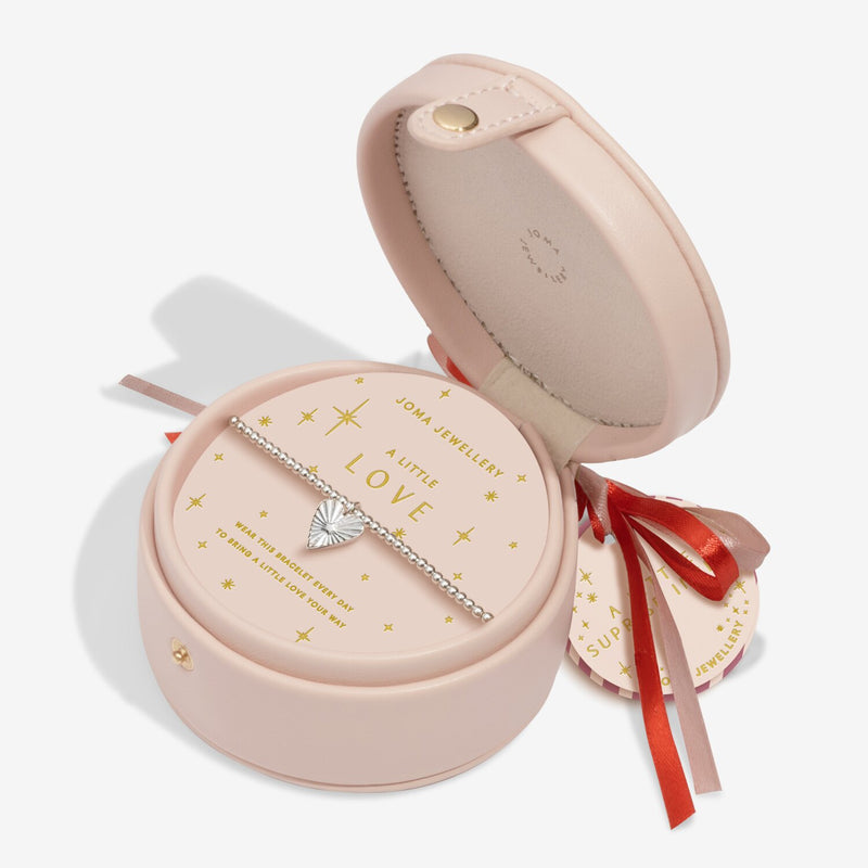 “Open blush bauble showing bracelet and starry message card”
