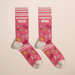 Pair of pink Accidentally Mean women’s crew novelty socks with lips, lipstick and heart icons