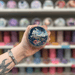 Alfresco Afternoon wax melt pot held in hand with colourful wax melt display in the background