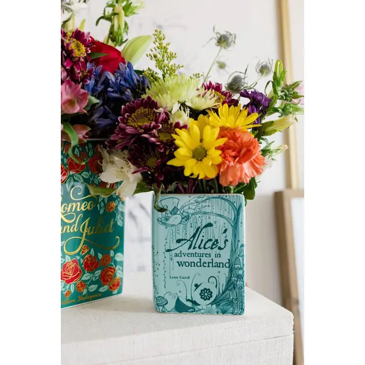 Alice in Wonderland book vase filled with colourful mixed flowers