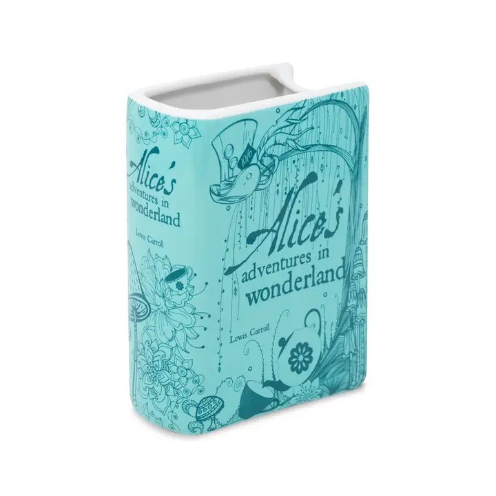 Side angle highlighting teapot and toadstool artwork on book vase