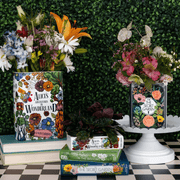 Home décor setup featuring Alice’s Adventures in Wonderland and The Secret Garden vases