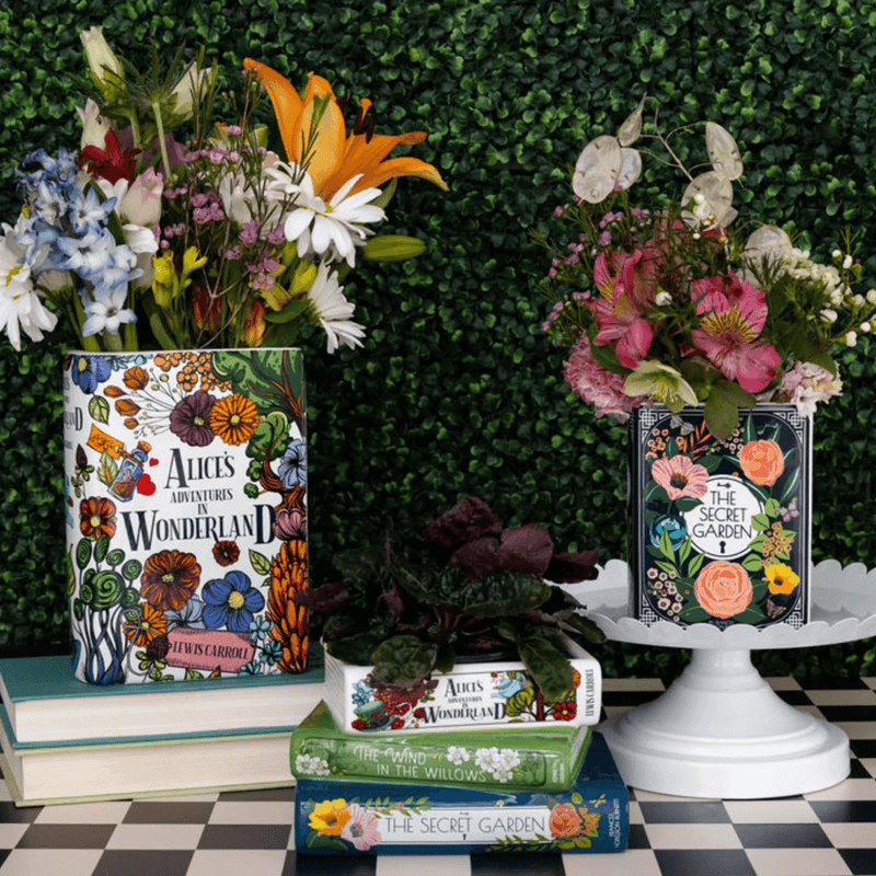 Home décor setup featuring Alice’s Adventures in Wonderland and The Secret Garden vases