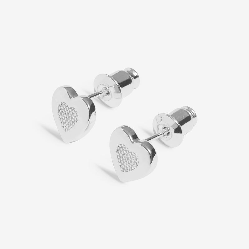 “Angled close‑up showing pavé detailing on heart stud earrings”
