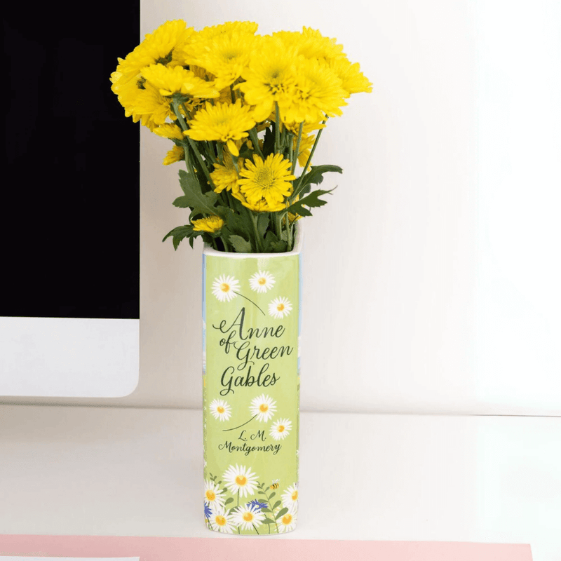 Slim spine view of Anne of Green Gables book vase with daisies and script title


