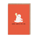 Minimal birthday greeting card showing white cartoon person sitting on orange background raising cupcake with lit candle
