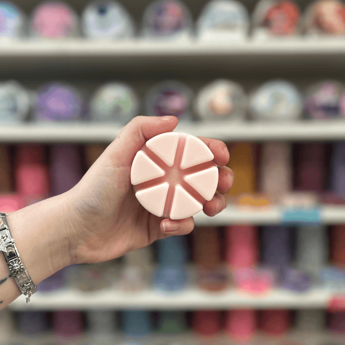 Aphrodite light pink segmented wax melt held in hand