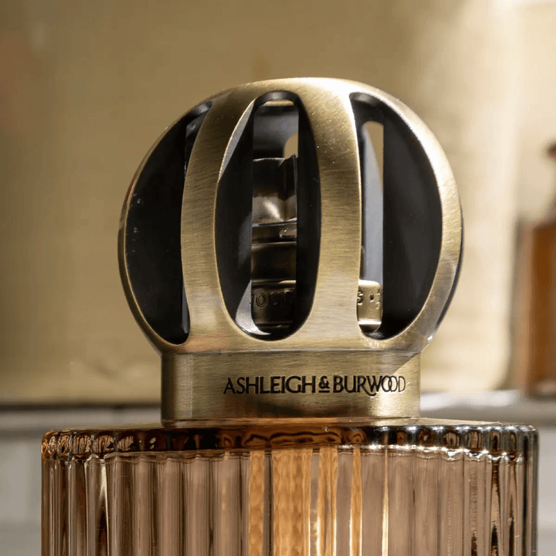 Close-up of the heavyweight metal crown and fluted glass on the Linear Truffle fragrance lamp