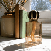 Ashleigh & Burwood Linear Truffle fluted-glass fragrance lamp displayed on a sunlit windowsill