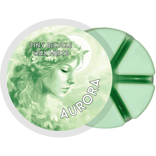 Fresh floral wax melt capturing the first light of dawn—crisp greenery, soft petals, and citrus air.