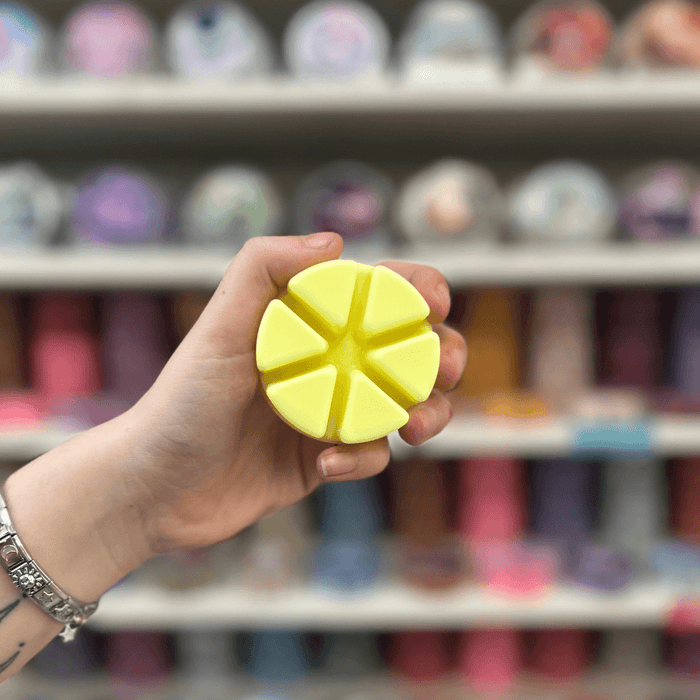 Banana Milkshake yellow segmented wax melt held in hand