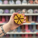 Banana Walnut Loaf wax melt segments held in hand with colourful wax melt display in the background