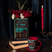 Beauty and the Beast ceramic book vase styled with flowers, matching mug and red candle