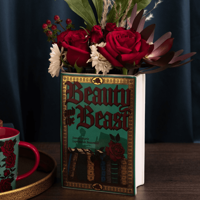 Beauty and the Beast ceramic book vase filled with red roses and decorative flowerss
