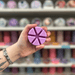 Bedtime Lavender wax melt segments held in hand with colourful wax melt display in the background