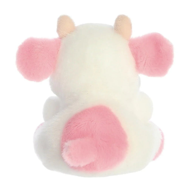 Rear view of Strawberry Cow plush toy with pink patch and stubby tail
