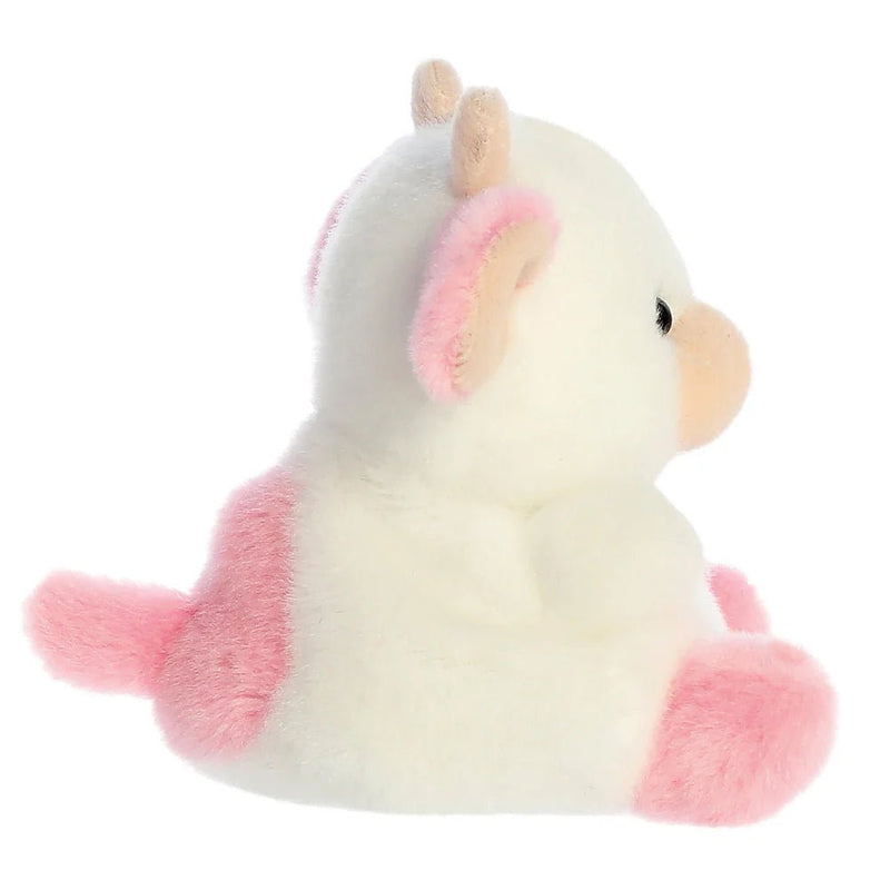 Side profile of Palm Pals Strawberry Cow plush showing curved horns and snout
