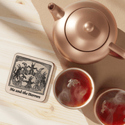 Betiobca Me and the Horrors gothic coaster shown on a table beside tea cups and a teapot
