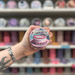 Birthday Cake wax melt pot held in hand with colourful wax melt display in the background