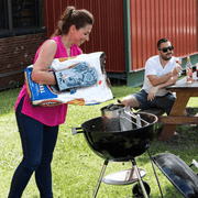Blue Q Bitches Get Stuff Done oven mitt being used at a BBQ