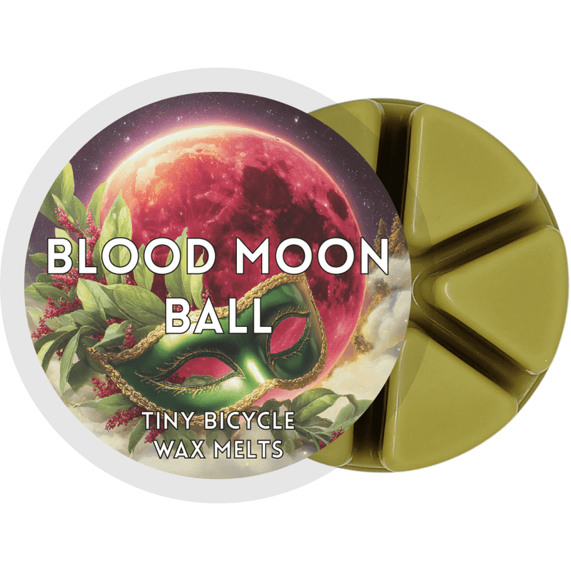 Blood Moon Ball wax melt label with crimson moon and green masquerade mask; spiced juniper, musk and cedar home fragrance wax melts