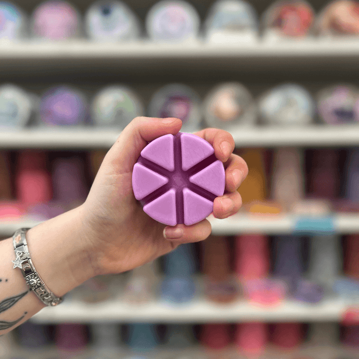 Bloomin Belle purple segmented wax melt held in hand