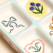 Detail of blue bow and floral ceramic trinket tray with illustrated compartments