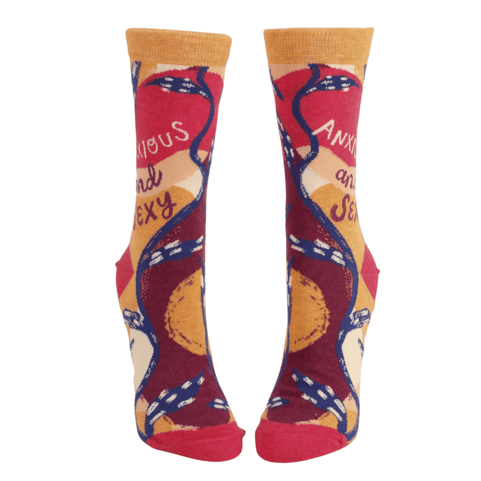 Front view of Blue Q women’s crew socks in orange, red and maroon with abstract pattern and the slogan Anxious and Sexy