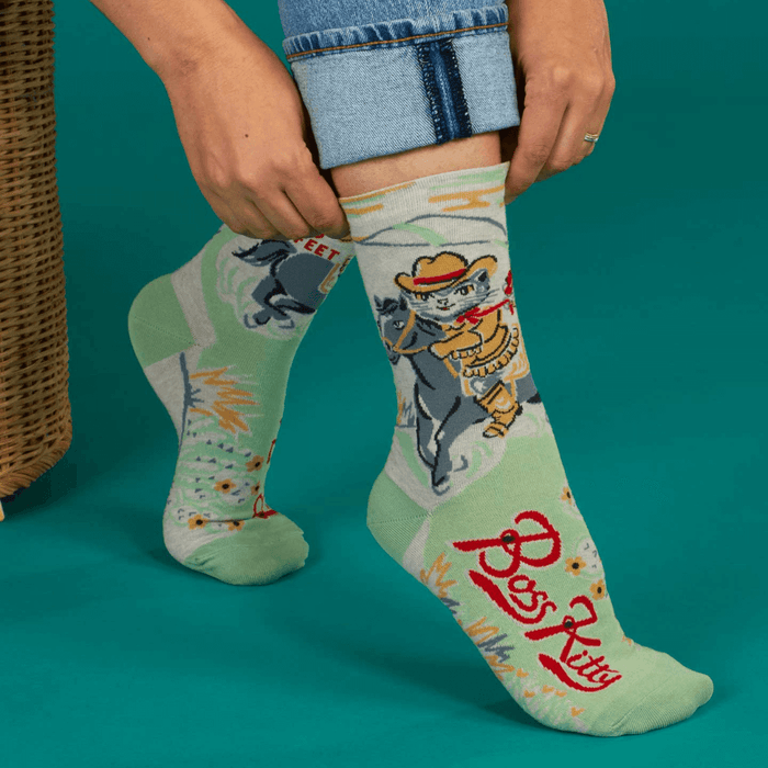 Blue Q Boss Kitty women’s crew socks with cowboy cat lasso design on mint green