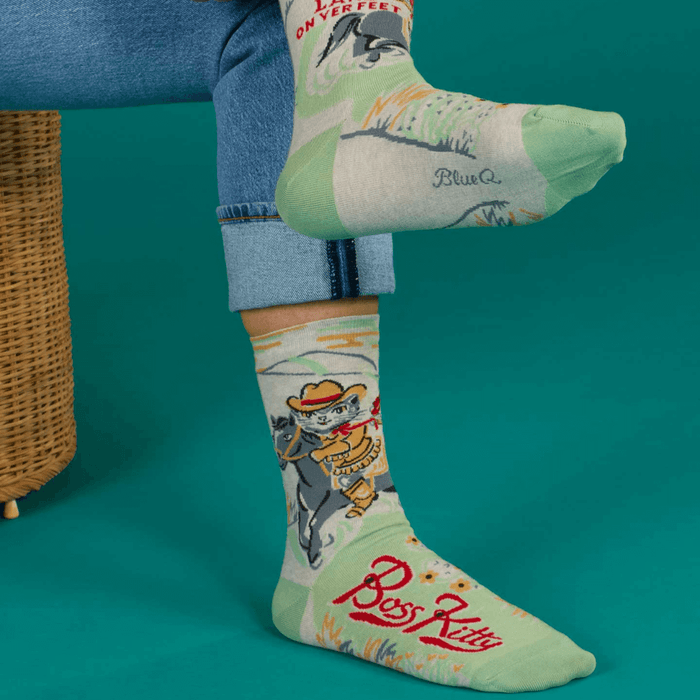 Model wearing Blue Q Boss Kitty women’s crew socks showing cowboy cat and Boss Kitty text