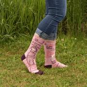 Person wearing Blue Q women’s crew socks reading “Go Away I’m Introverting” in pink and burgundy