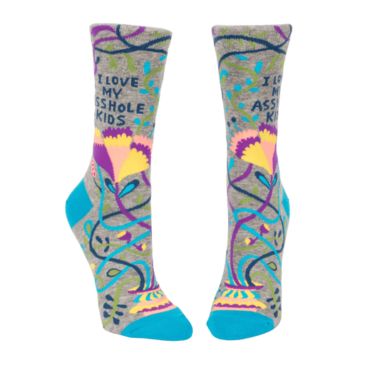 Front view of Blue Q women’s crew socks in grey with teal toe and heel, bold floral vines and the slogan I love my asshole kids