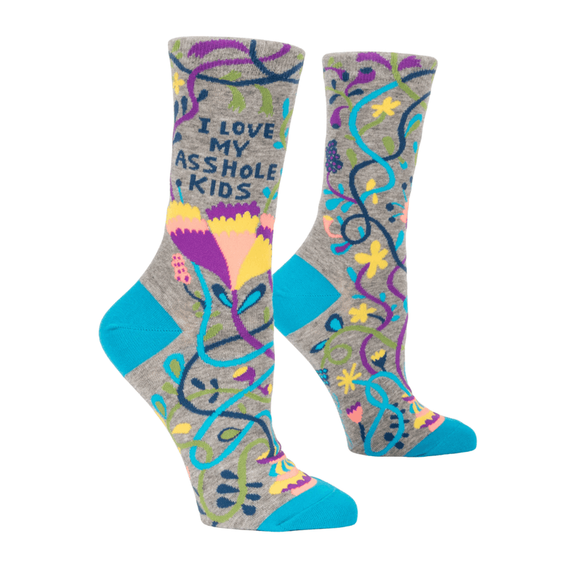 Angled view of Blue Q grey crew socks showing colourful floral pattern, teal accents and I love my asshole kids slogan