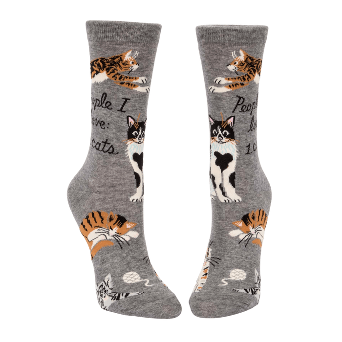Front view of Blue Q cat lover crew socks with multiple cat illustrations and yarn motifs