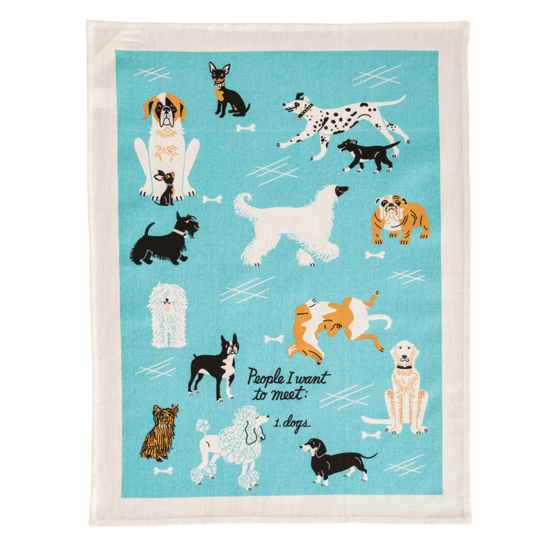 Flat lay of Blue Q tea towel with illustrated dogs and text “People I want to meet: 1. dogs” on blue background

