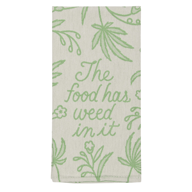 Front of Blue Q The Food Has Weed In It tea towel with bold food-themed design