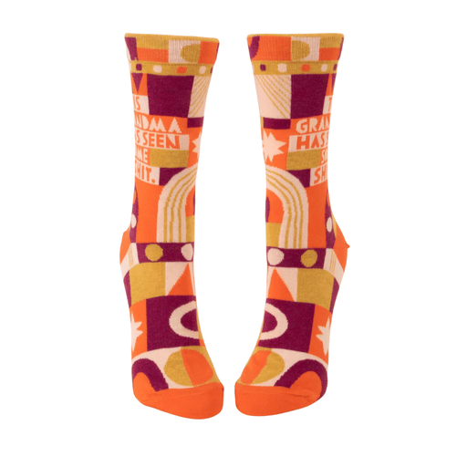 Blue Q women’s crew socks with retro orange and purple pattern reading This Grandma Has Seen Some Shit, front view.