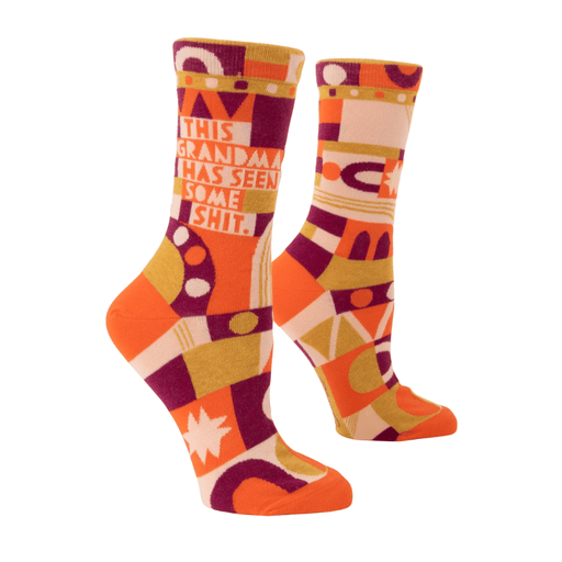 Side view of Blue Q women’s crew socks with bold text This Grandma Has Seen Some Shit and 70s geometric design in orange and purple.