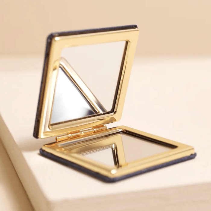 Open blue starry night compact mirror showing two mirrors and rose gold frame