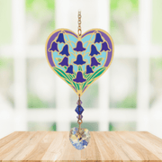 Heart-shaped Bluebell Crystal Suncatcher with bluebell motif and faceted heart prism catching light in a sunny window


