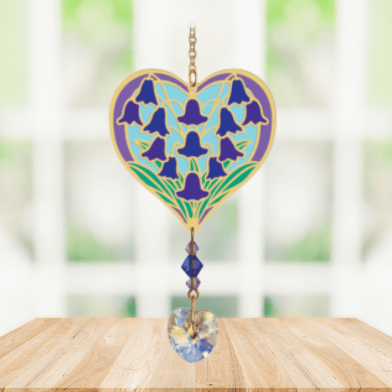 Heart-shaped Bluebell Crystal Suncatcher with bluebell motif and faceted heart prism catching light in a sunny window

