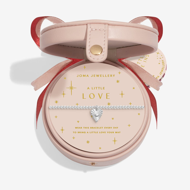 “Blush‑pink round bauble gift box holding ‘A Little Love’ bracelet”
