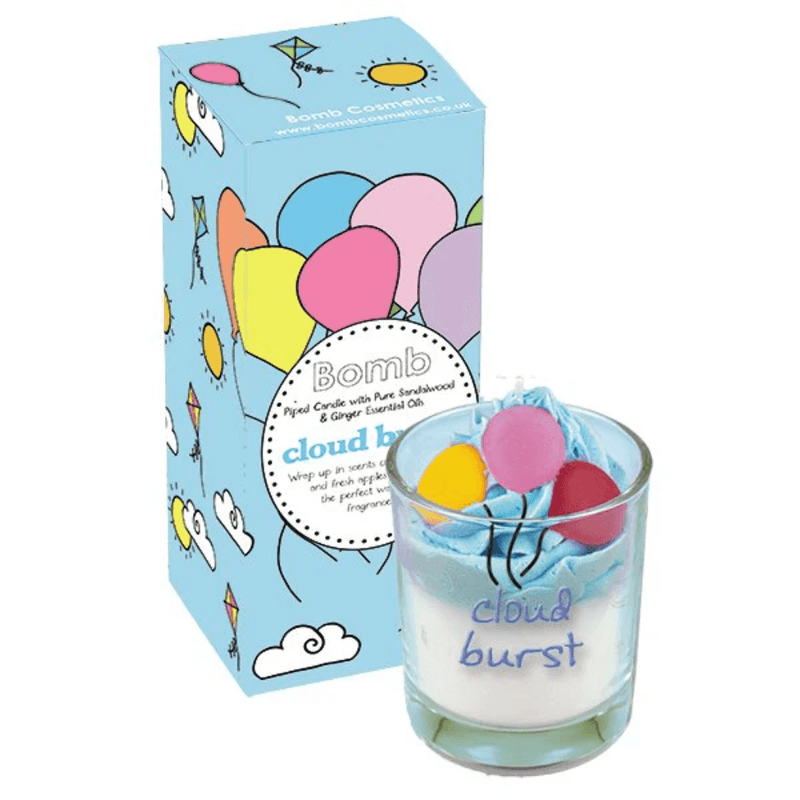 Bomb Cosmetics Cloud Burst piped scented candle—blue whipped wax with balloon toppers in glass jar, shown beside sky-blue gift box.