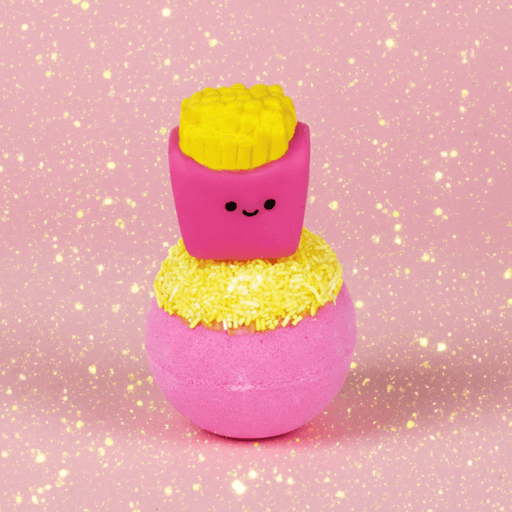 Bomb Cosmetics Fizzy Fries Bath Blaster with cute fries topper on a pink glittery background
