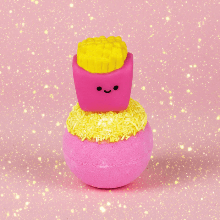 Bomb Cosmetics Fizzy Fries Bath Blaster with cute fries topper on a pink glittery background